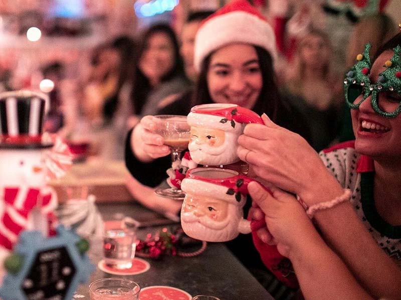 people toasting with santa mugs at 158 on main mooresville nc